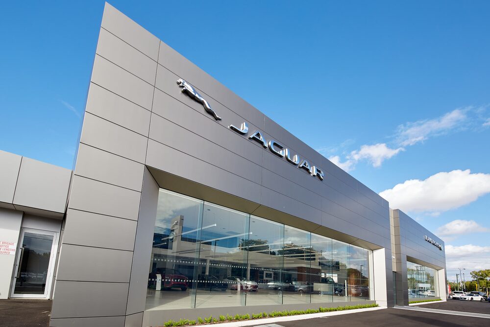 Jaguar dealership with a long glazed showroom and silver cladding