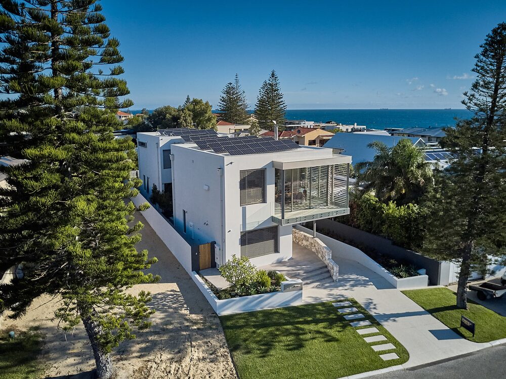 Aerial view of a contemporary coastal home with the ocean behind