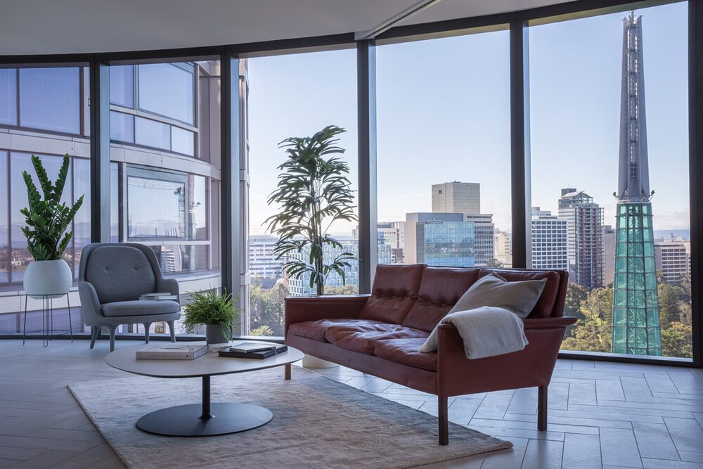 Hotel lounge with floor to ceiling glazing and views over the Perth skyline